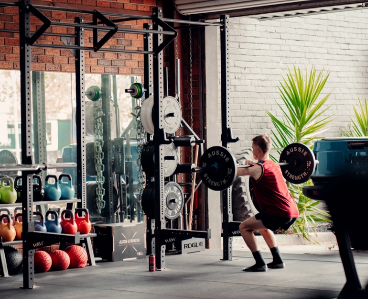 Man squatting with barbell
