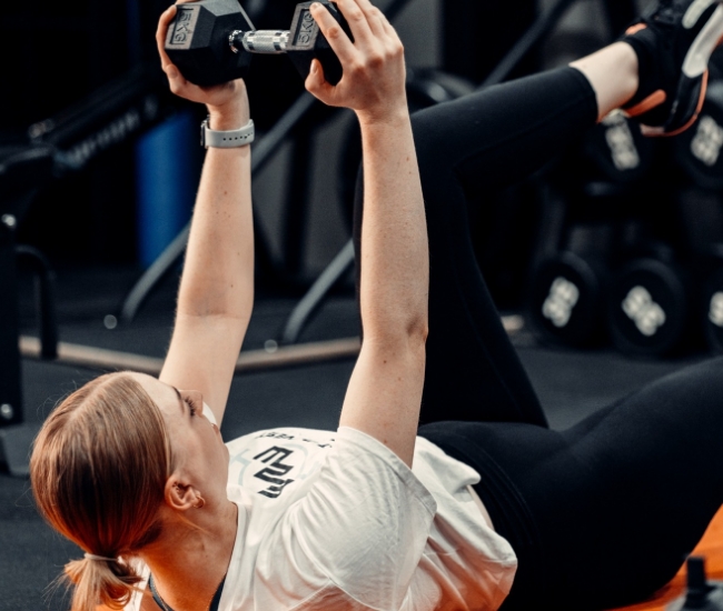 Woman lifting dumbbell overhead