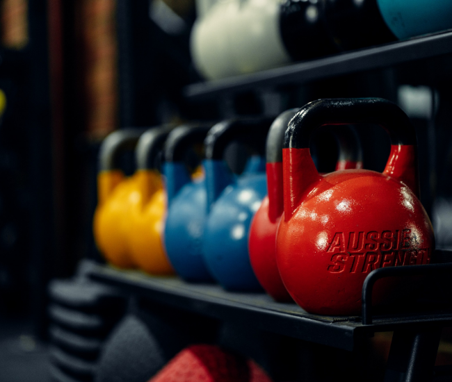Colorful kettlebells on shelf