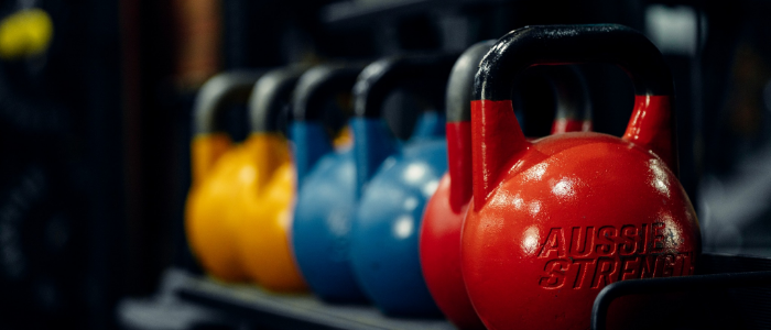 Colorful gym kettlebells on rack