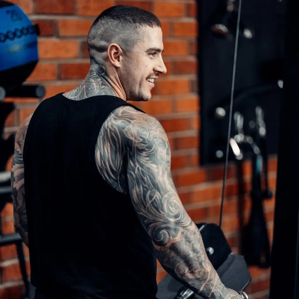 Man with tattoos working out